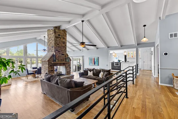 a kitchen with stainless steel appliances a sink cabinets and wooden floor