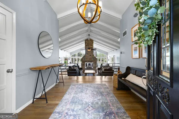 a living room with furniture and a chandelier