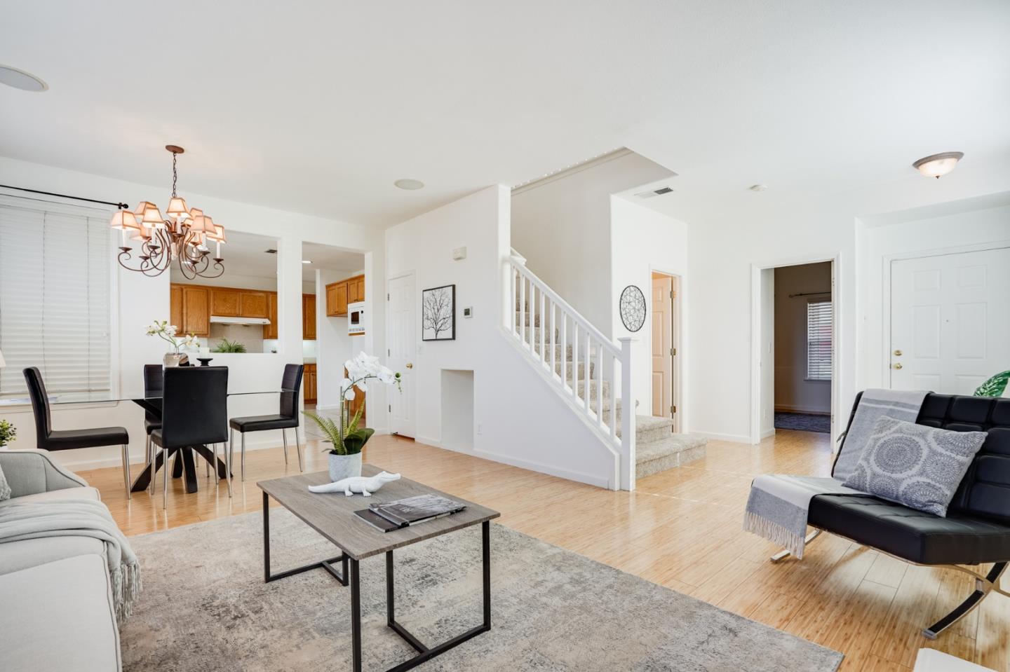 779 Canoas Creek Circle San Jose, CA 95136 - Photo 11 of 58 a living room with furniture dining table and a chandelier