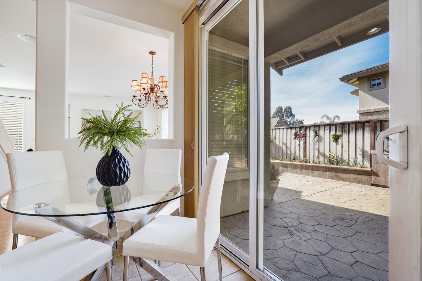 779 Canoas Creek Circle San Jose, CA 95136 - Photo 20 of 58 a vase of flowers sitting on a table with a glass door