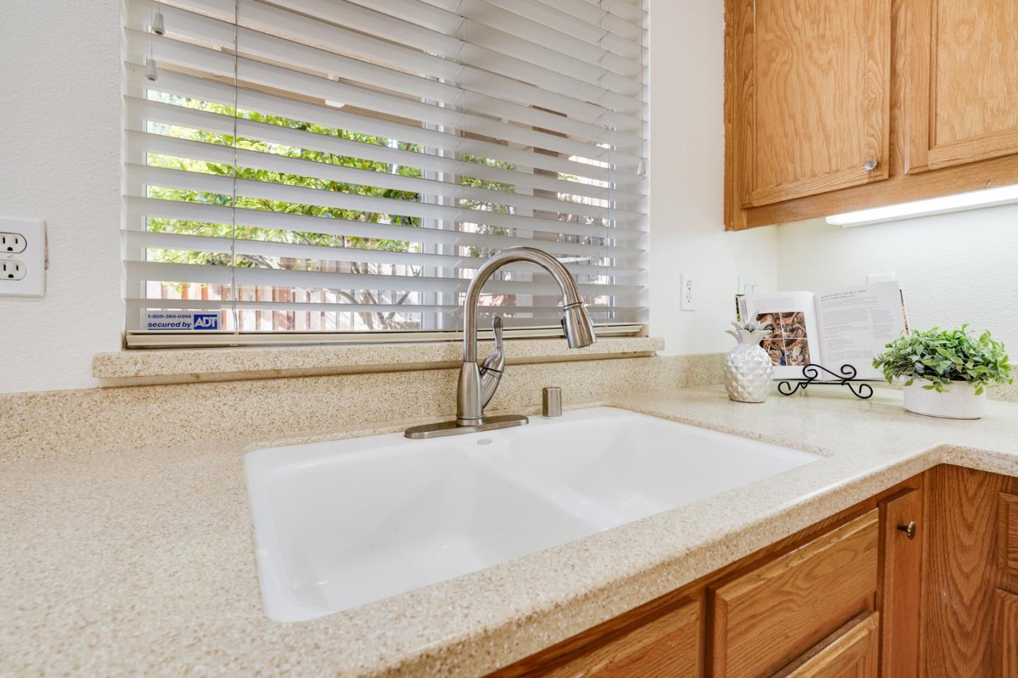 779 Canoas Creek Circle San Jose, CA 95136 - Photo 23 of 58 a kitchen with granite countertop a sink and a window