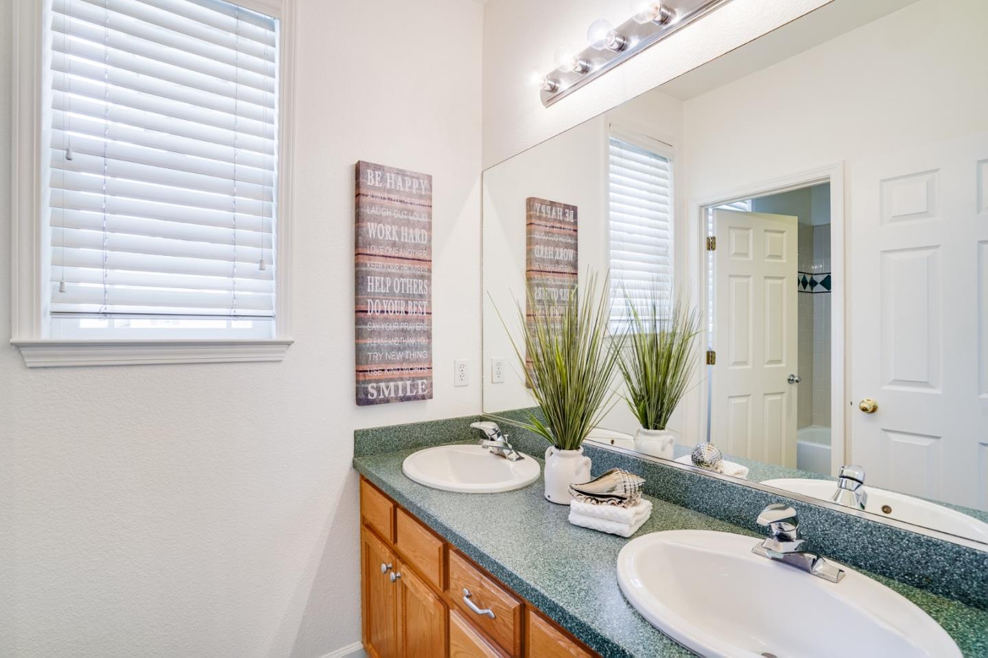 779 Canoas Creek Circle San Jose, CA 95136 - Photo 43 of 58 a bathroom with a granite countertop sink and a mirror
