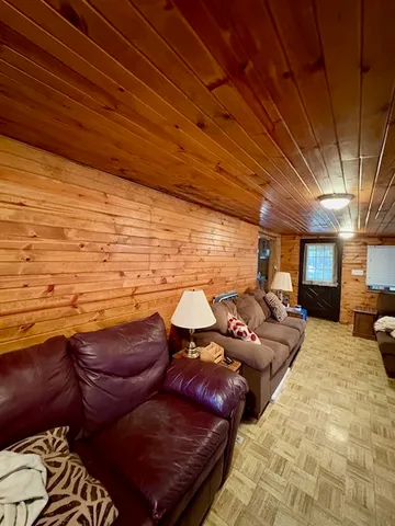 a dining room with furniture and a floor to ceiling window
