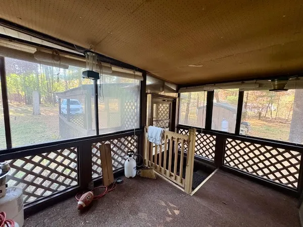 a living room with furniture and kitchen view