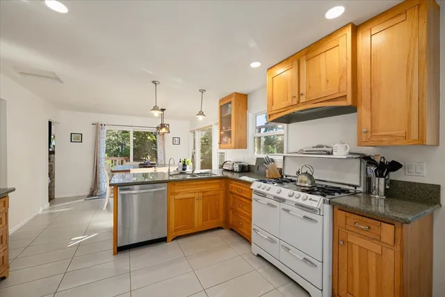a bathroom with a granite countertop sink a mirror a bathtub and shower
