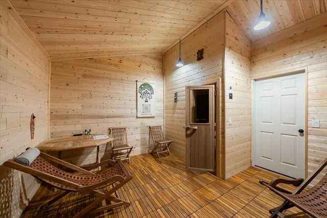 a front view of house with yard and trees around