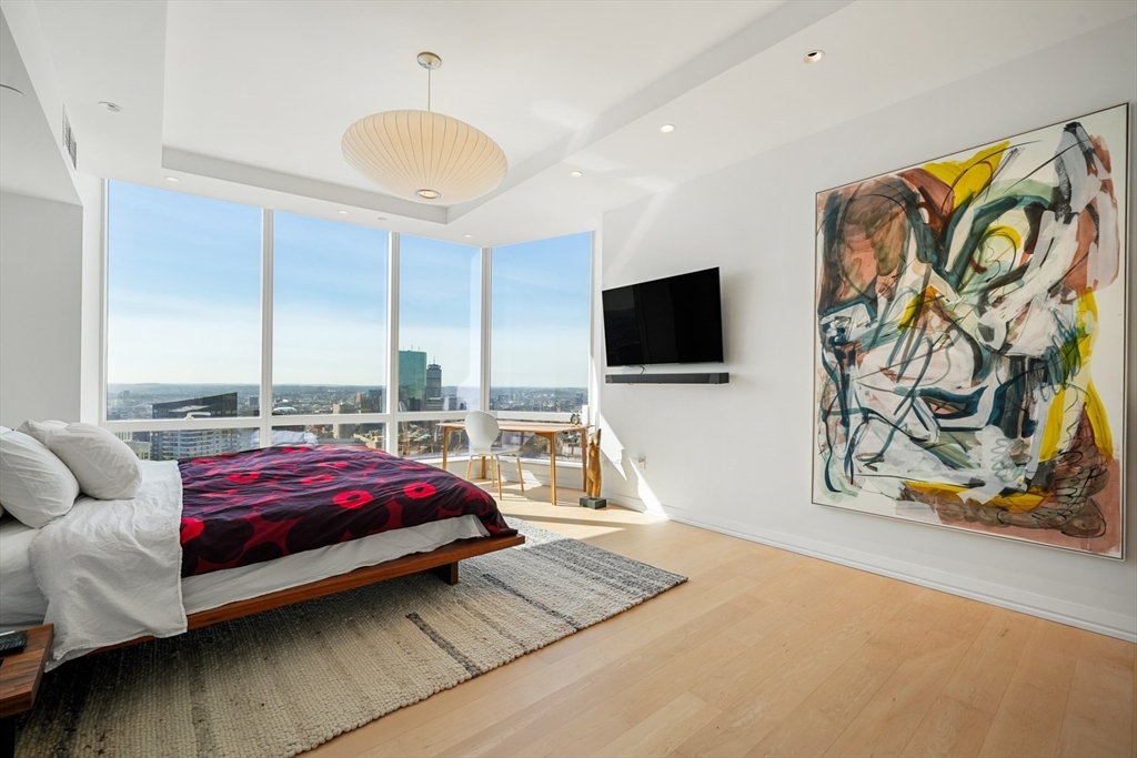 1 Franklin Street, Unit 4802 Boston, MA 02110 - Photo 25 of 42 a bedroom with a bed and flat screen tv