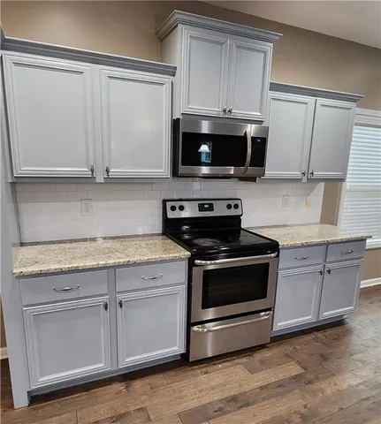 a kitchen with granite countertop a stove and a sink