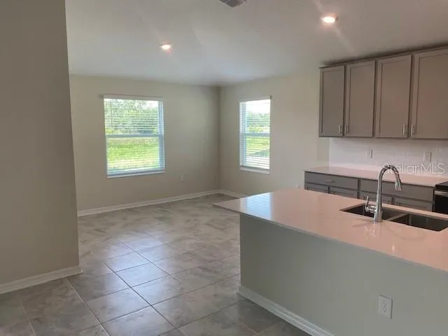 a kitchen with a sink cabinets and window