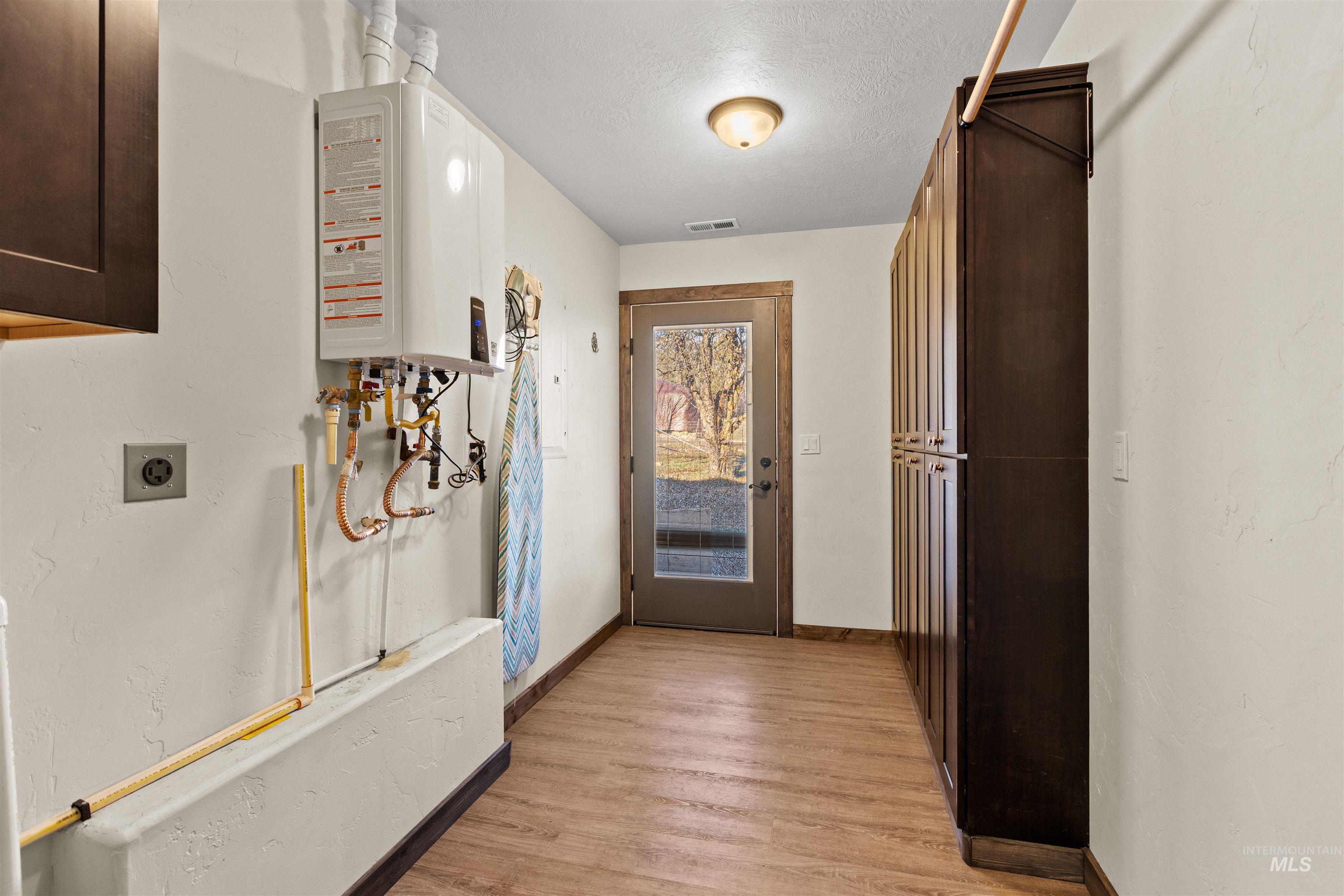 3488 Ward Road Cambridge, ID 83610 - Photo 22 of 50 Hallway featuring a textured ceiling and wood finished floors