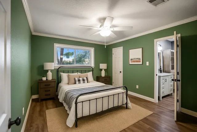 a bedroom with a large bed and a chandelier