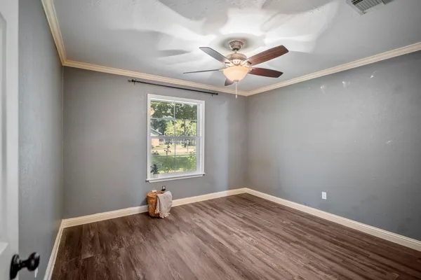a spacious bathroom with a sink and a mirror