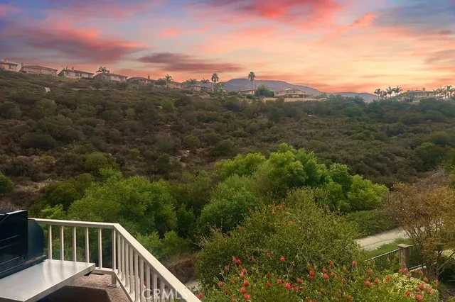 a view of a city with lush green forest