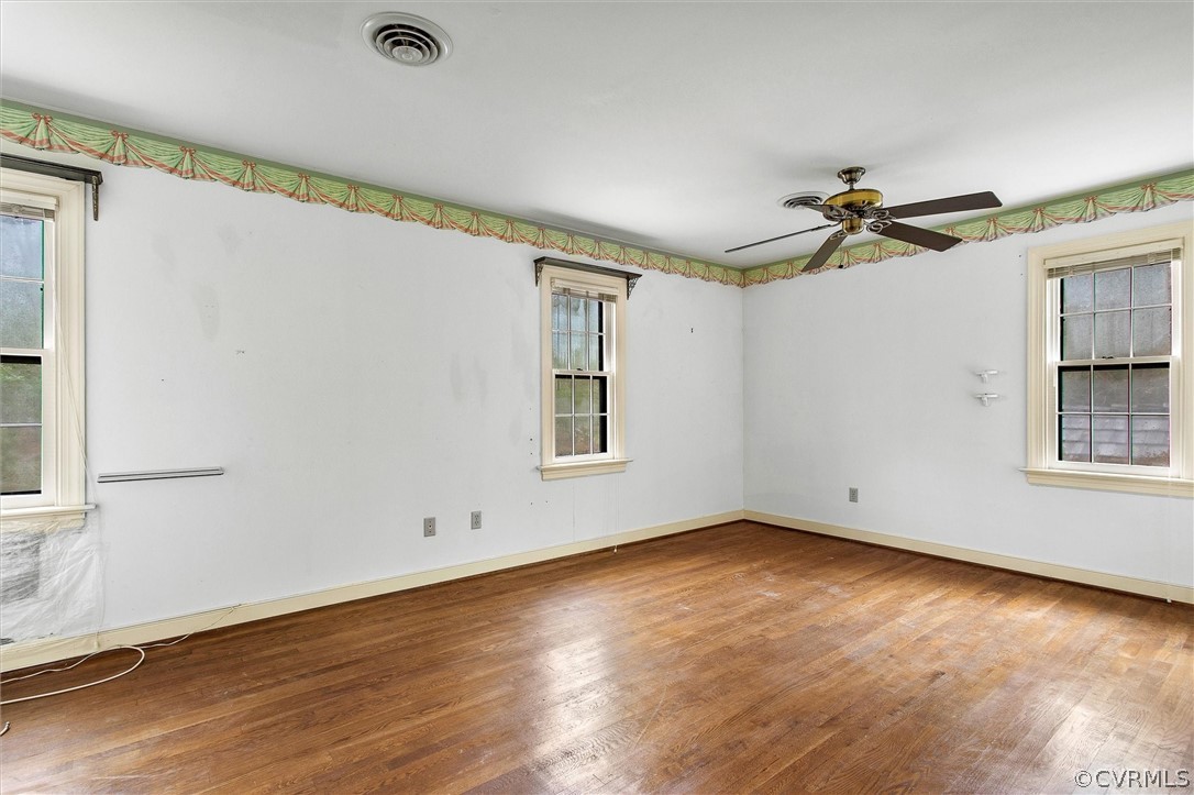 3802 Pebble Creek Road Midlothian, VA 23112 - Photo 18 of 25 an empty room with wooden floor chandelier fan and windows
