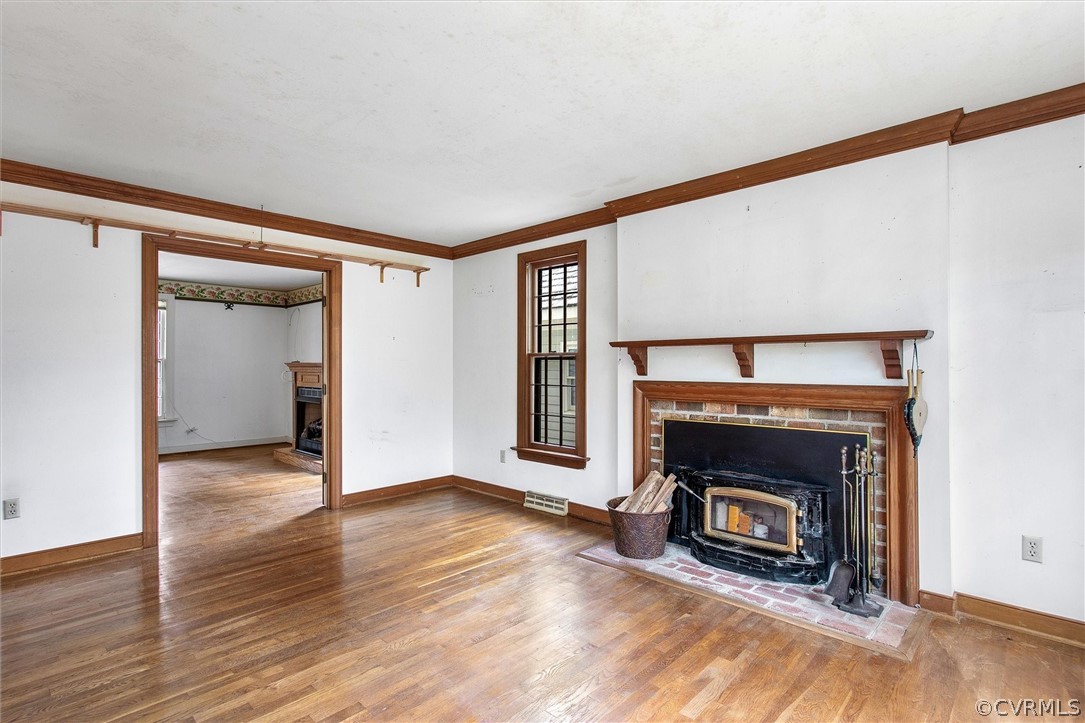 3802 Pebble Creek Road Midlothian, VA 23112 - Photo 5 of 25 a view of an empty room with wooden floor fireplace and a window