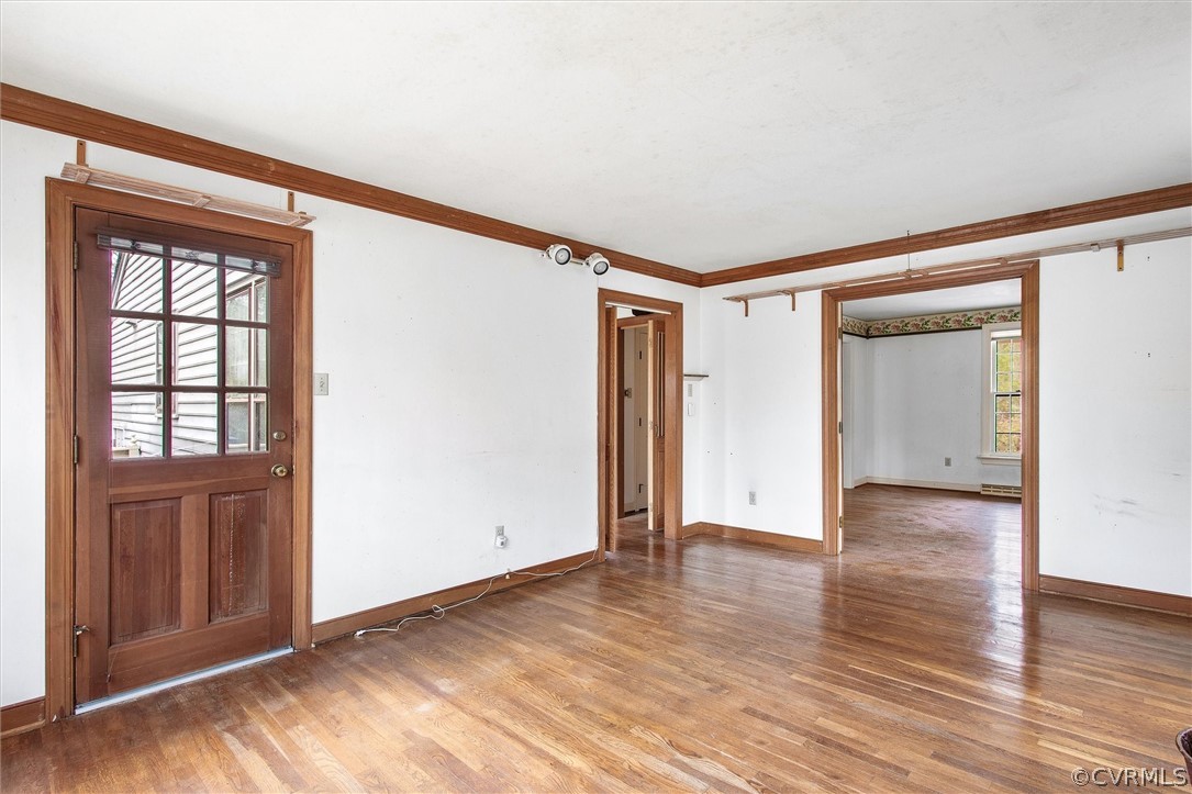3802 Pebble Creek Road Midlothian, VA 23112 - Photo 6 of 25 a view of an empty room with wooden floor and a window