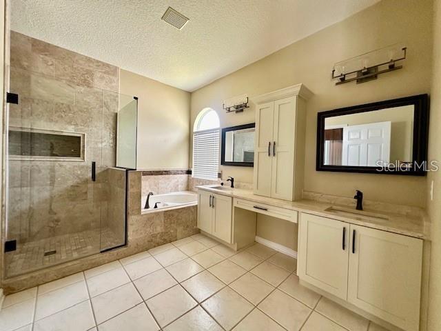 806 Winder Oaks Drive Gotha, FL 34734 - Photo 17 of 47 a large white bathroom with a double vanity sink a mirror and a bathtub