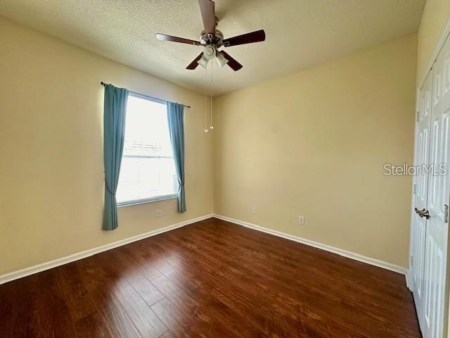 806 Winder Oaks Drive Gotha, FL 34734 - Photo 24 of 47 an empty room with wooden floor fan and windows