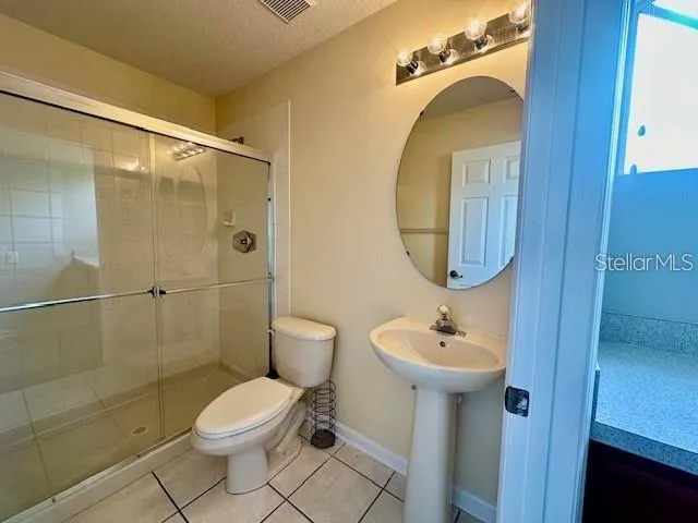 a bathroom with a toilet sink and shower