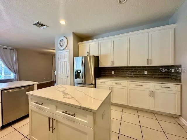 a kitchen with a stove cabinets and a refrigerator