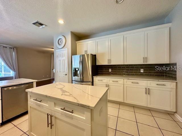 806 Winder Oaks Drive Gotha, FL 34734 - Photo 6 of 47 a kitchen with a stove cabinets and a refrigerator