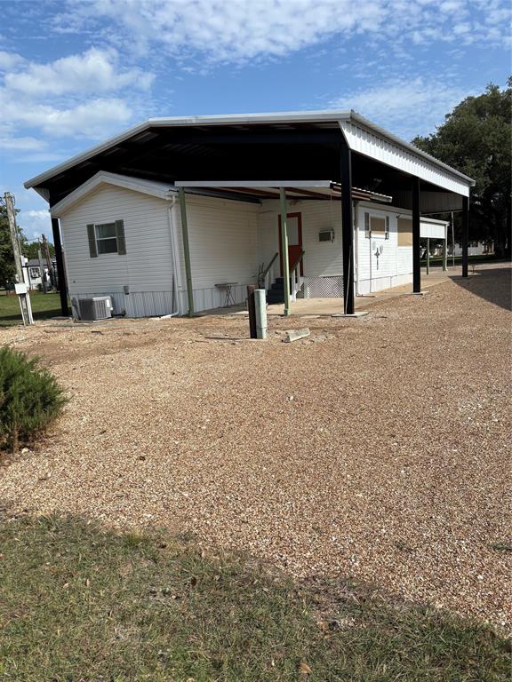 206 Holiday Rambler Drive Whitney, TX 76692 - Photo 26 of 28 White-sided structure featuring an expansive black metal awning supported by black posts