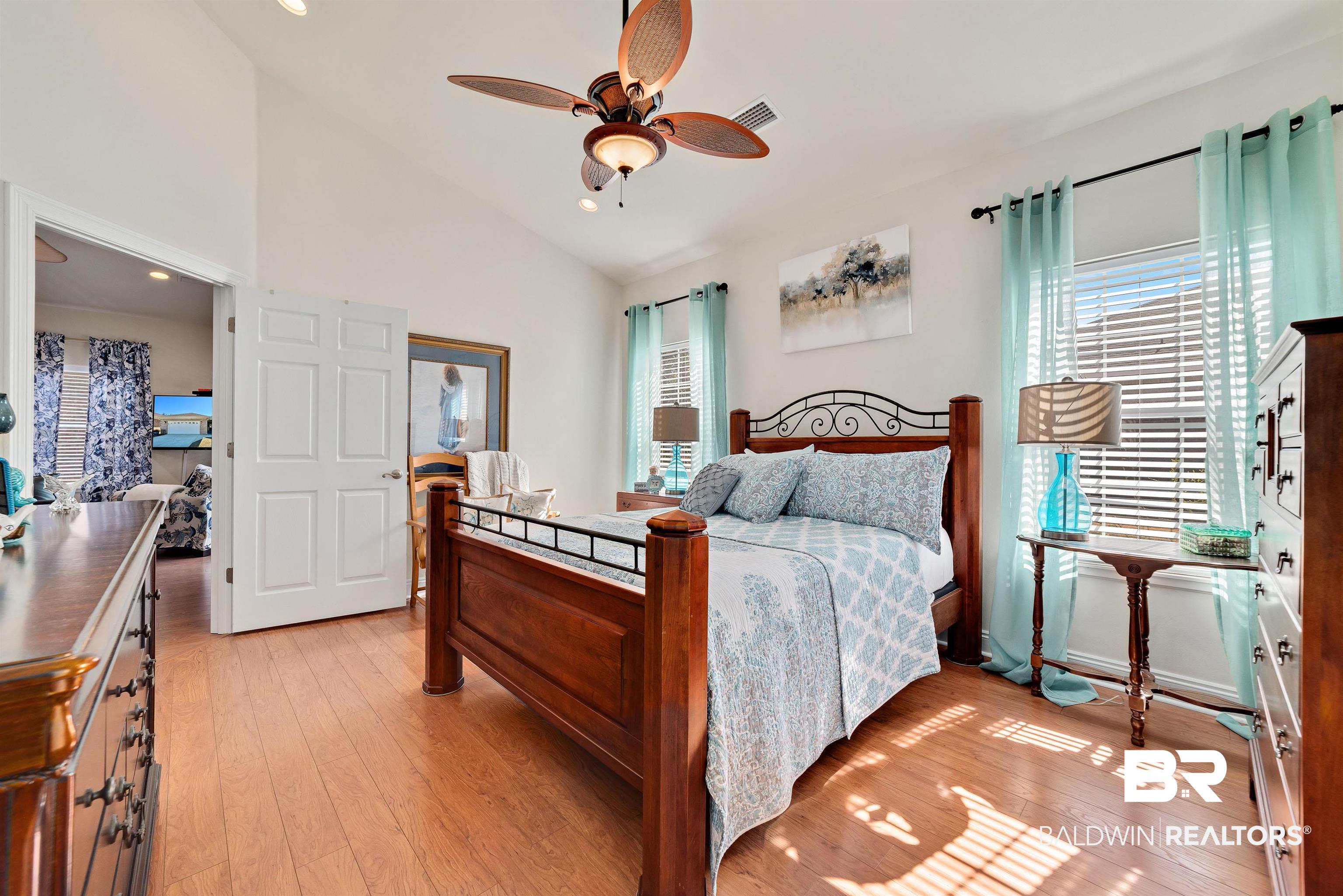 218 Hemingway Loop Foley, AL 36535 - Photo 18 of 39 Bedroom featuring vaulted ceiling, multiple windows, light wood-style floors, recessed lighting, and a ceiling fan