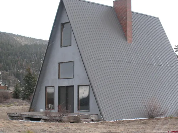 a front view of a house with parking space