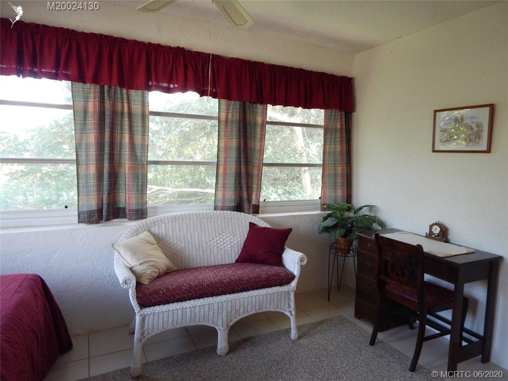 2950 Southeast Ocean Boulevard, Unit 1225 Stuart, FL 34996 - Photo 11 of 39 a living room with furniture and a potted plant