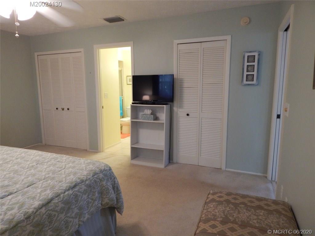 2950 Southeast Ocean Boulevard, Unit 1225 Stuart, FL 34996 - Photo 13 of 39 a bedroom with a bed and a flat screen tv