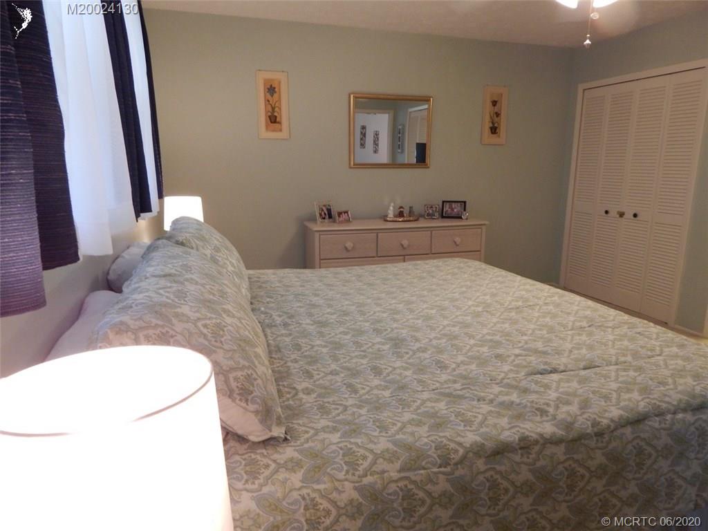 2950 Southeast Ocean Boulevard, Unit 1225 Stuart, FL 34996 - Photo 14 of 39 a bedroom with a bed and a refrigerator