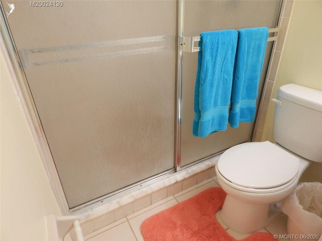 2950 Southeast Ocean Boulevard, Unit 1225 Stuart, FL 34996 - Photo 18 of 39 a bathroom with a toilet and a shower