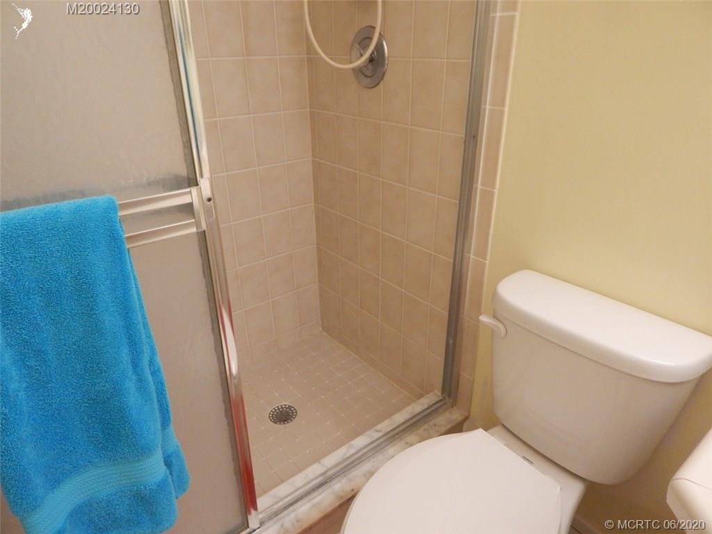 2950 Southeast Ocean Boulevard, Unit 1225 Stuart, FL 34996 - Photo 20 of 39 a bathroom with a toilet and shower