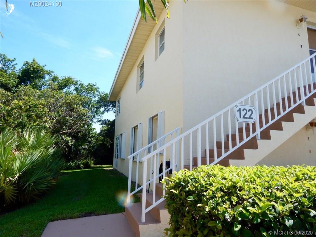 2950 Southeast Ocean Boulevard, Unit 1225 Stuart, FL 34996 - Photo 2 of 39 a view of a house with backyard and garden