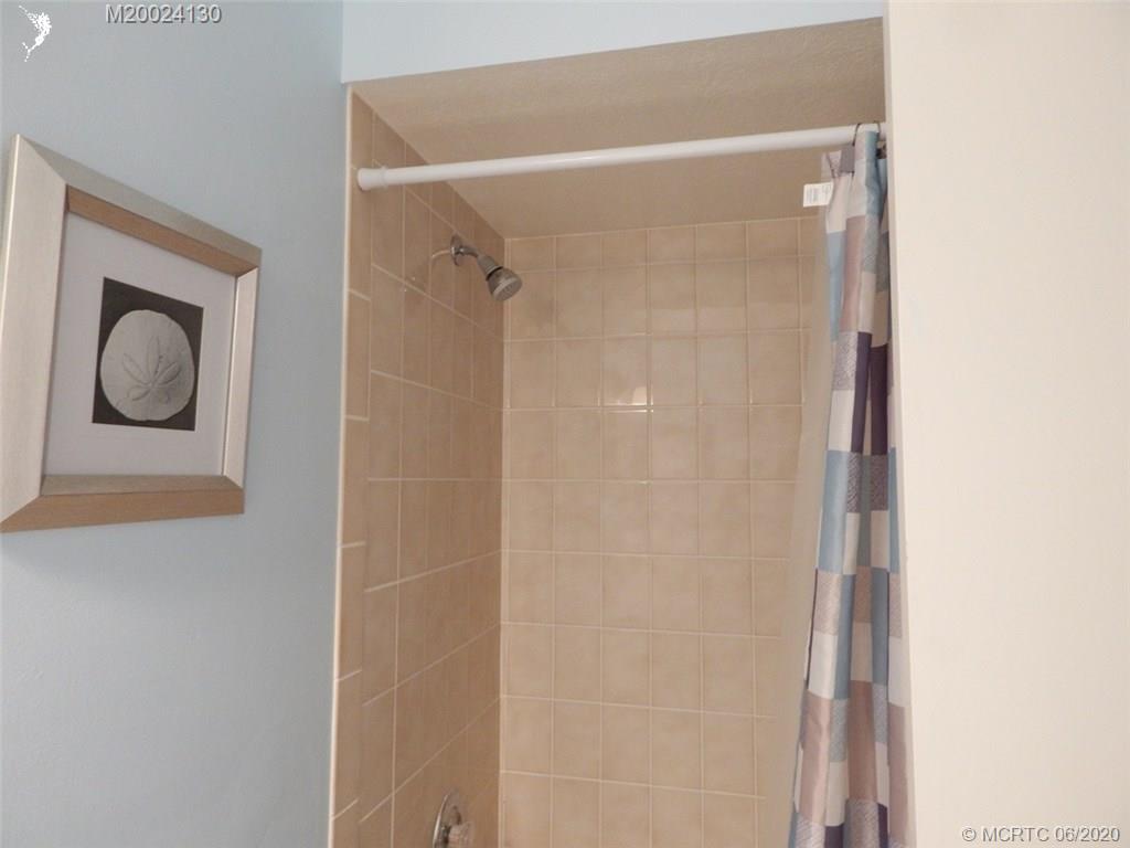 2950 Southeast Ocean Boulevard, Unit 1225 Stuart, FL 34996 - Photo 30 of 39 a bathroom with a mirror