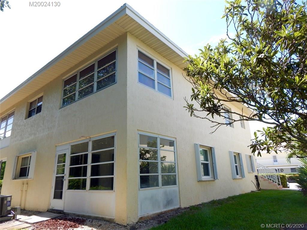 2950 Southeast Ocean Boulevard, Unit 1225 Stuart, FL 34996 - Photo 3 of 39 a front view of a house with a yard