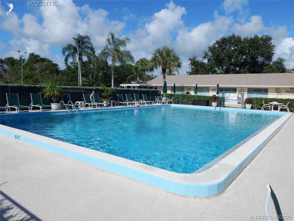 2950 Southeast Ocean Boulevard, Unit 1225 Stuart, FL 34996 - Photo 35 of 39 a view of swimming pool with outdoor seating and lake view