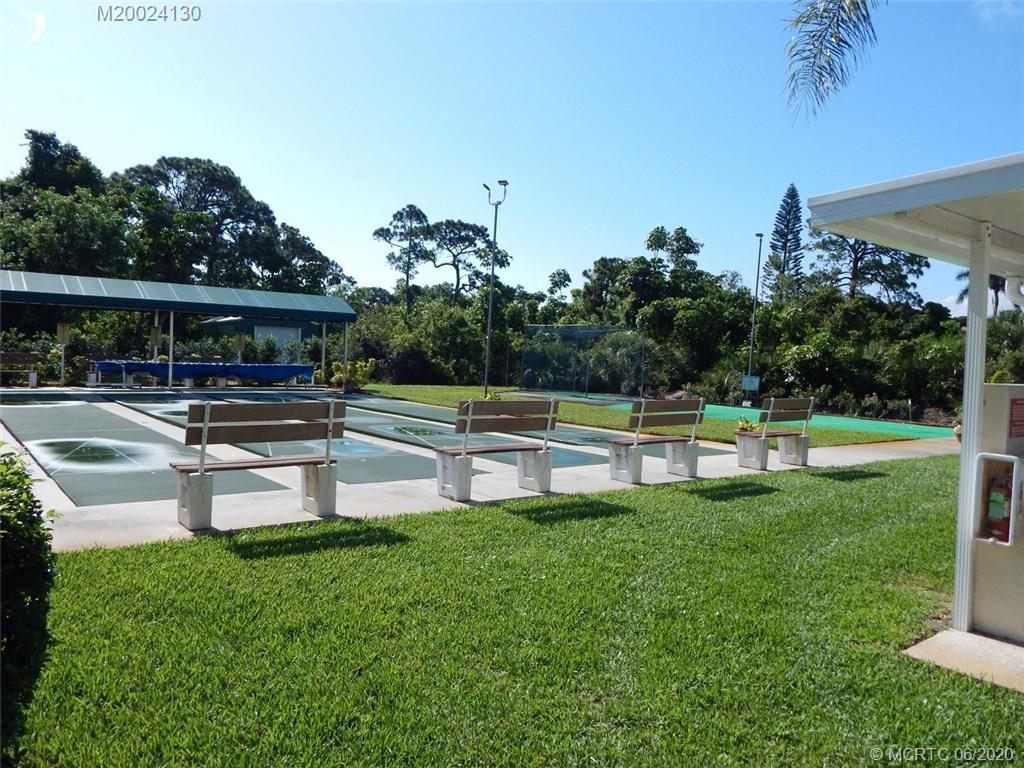 2950 Southeast Ocean Boulevard, Unit 1225 Stuart, FL 34996 - Photo 36 of 39 a swimming pool with outdoor seating and yard