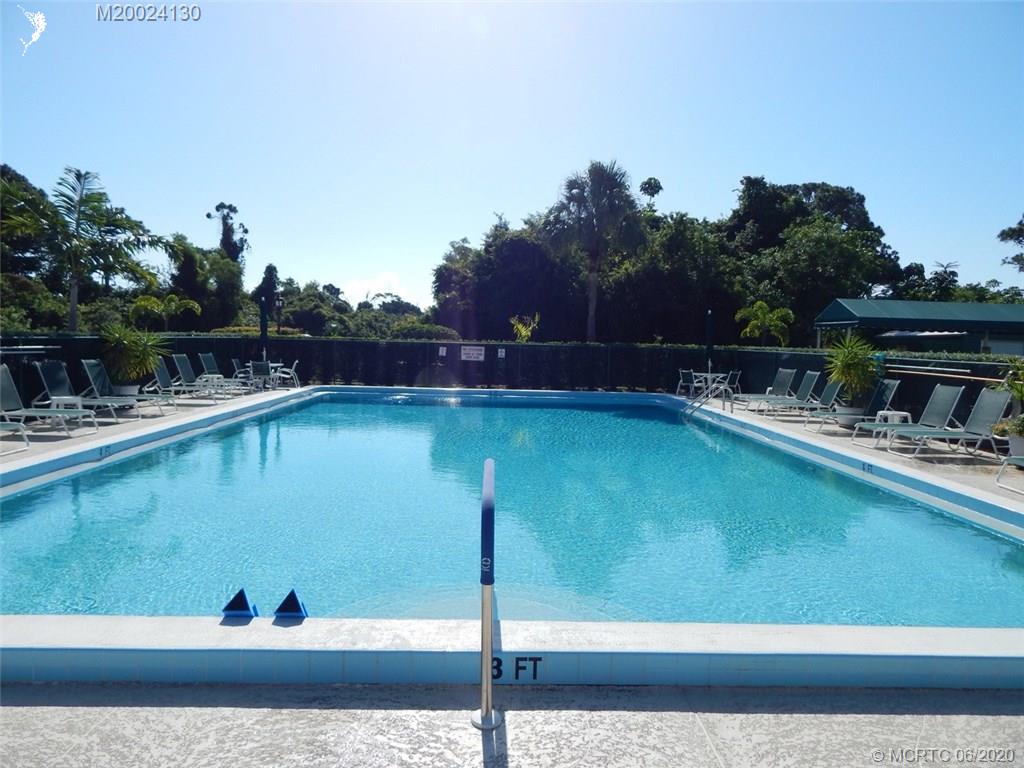 2950 Southeast Ocean Boulevard, Unit 1225 Stuart, FL 34996 - Photo 38 of 39 a view of a swimming pool with a yard