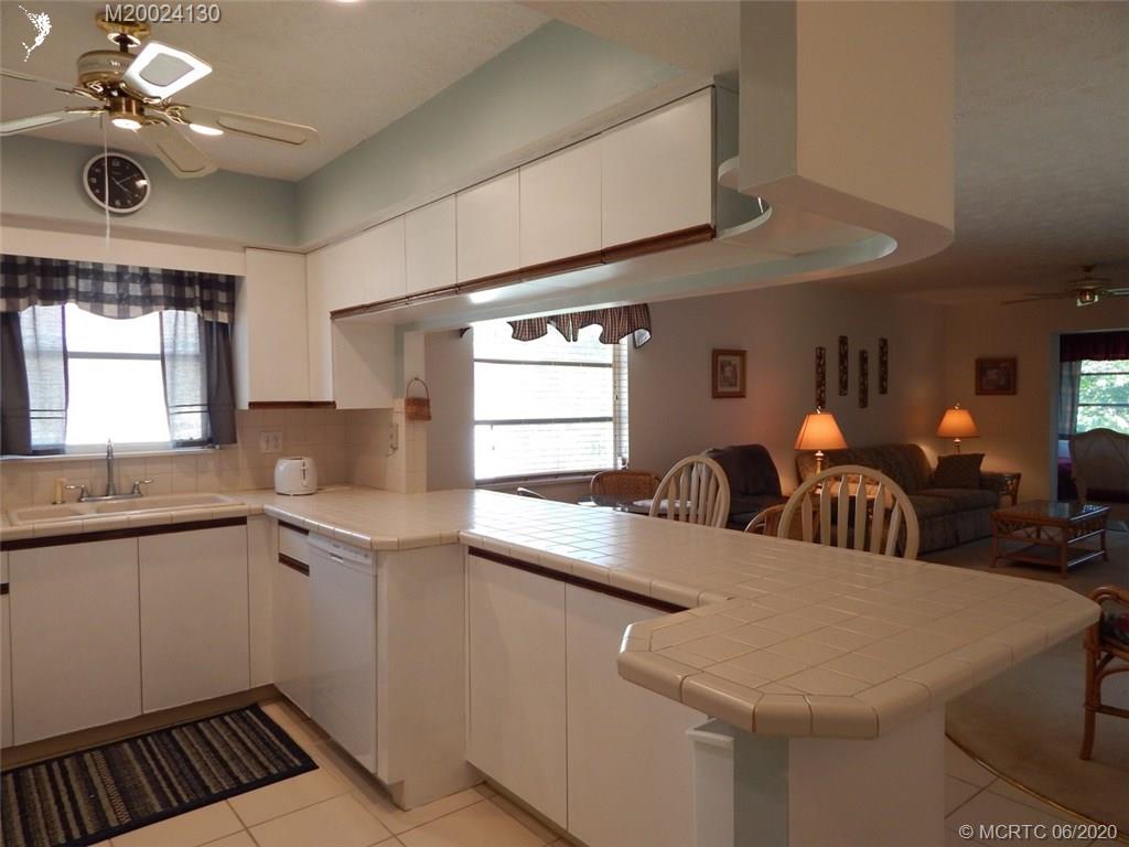 2950 Southeast Ocean Boulevard, Unit 1225 Stuart, FL 34996 - Photo 4 of 39 a kitchen with sink and view of living room