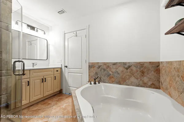 a view of a house with a big yard and palm trees