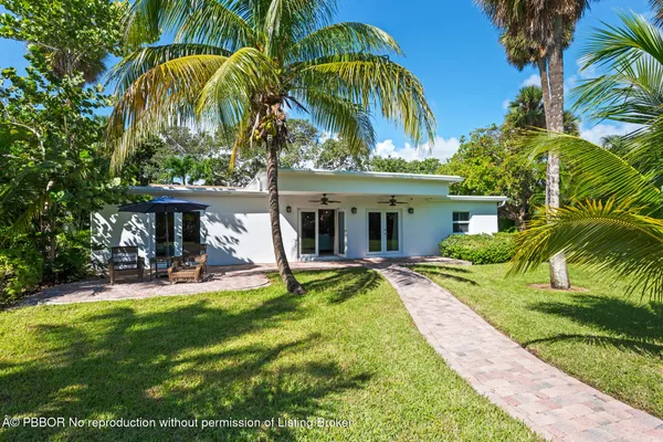 a dining room with furniture and floor to ceiling window