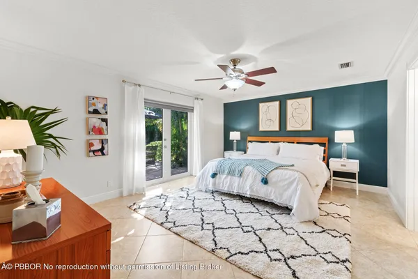 a bedroom with a bed a couch and a chandelier