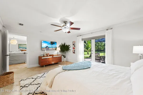 a view of a patio with table and chairs under an umbrella