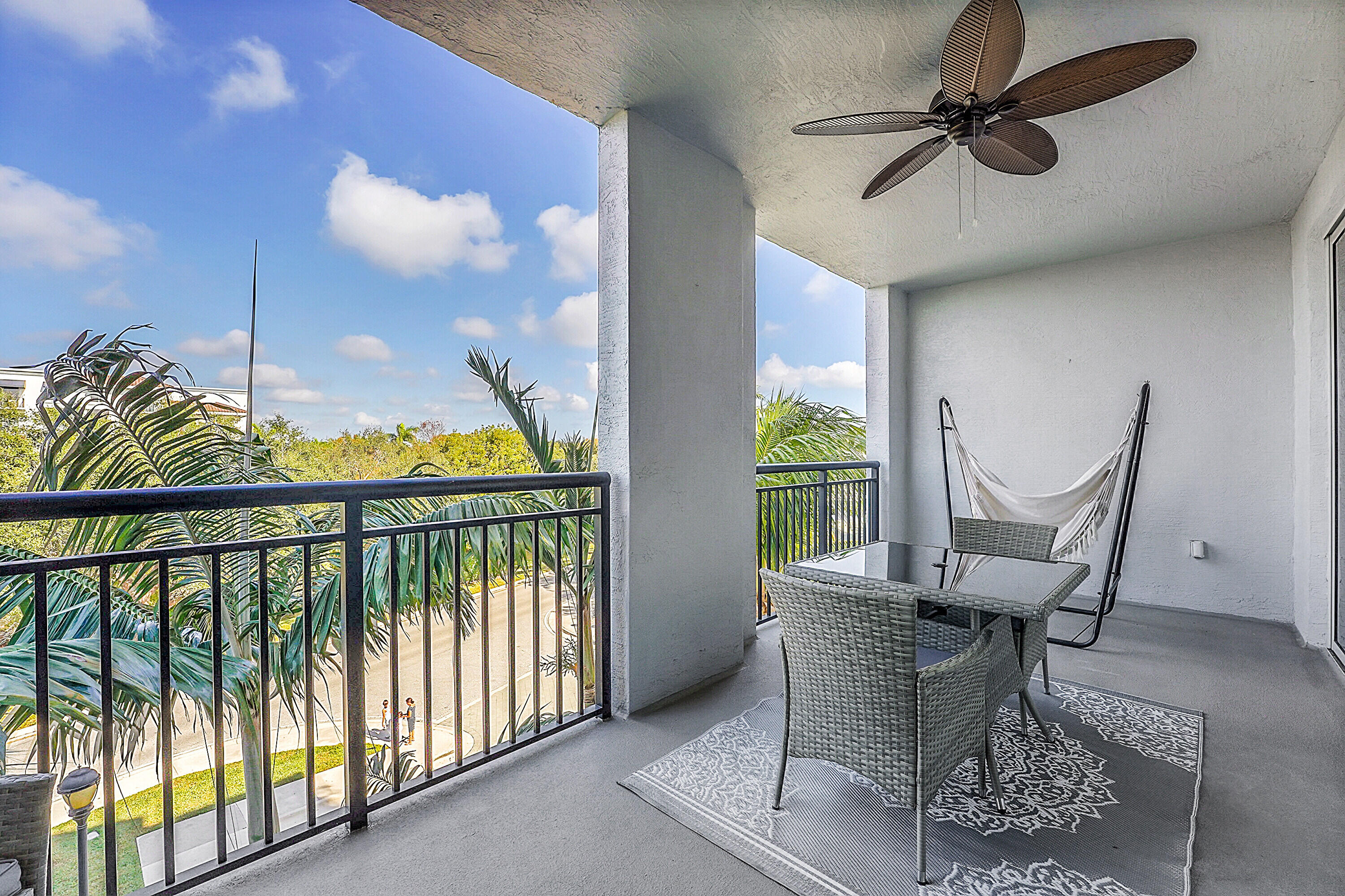 1690 Renaissance Commons Boulevard, Unit 1401 Boynton Beach, FL 33426 - Photo 11 of 43 a balcony with furniture and a potted plant