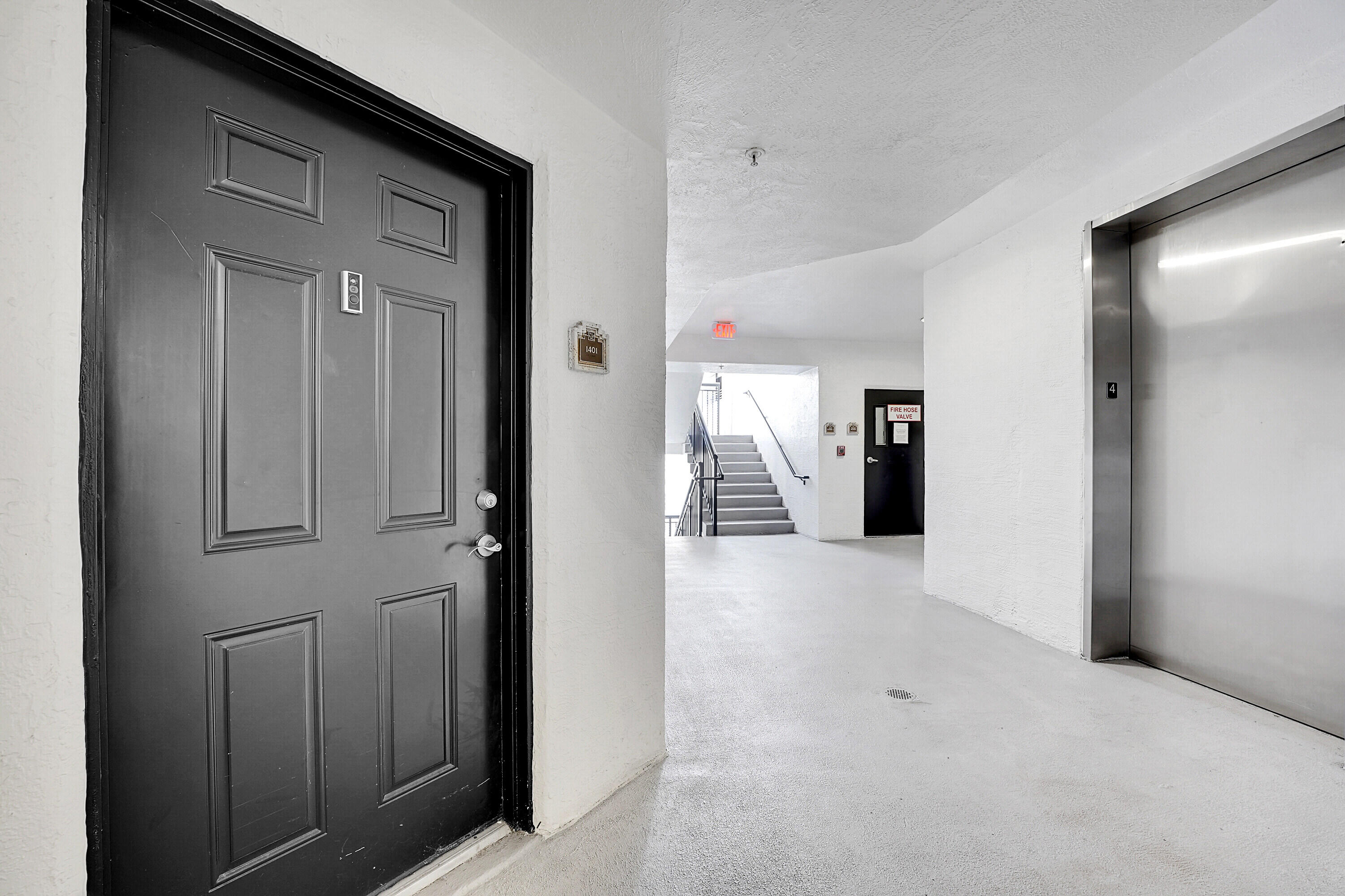 1690 Renaissance Commons Boulevard, Unit 1401 Boynton Beach, FL 33426 - Photo 2 of 43 a view of a hallway with wooden shelves