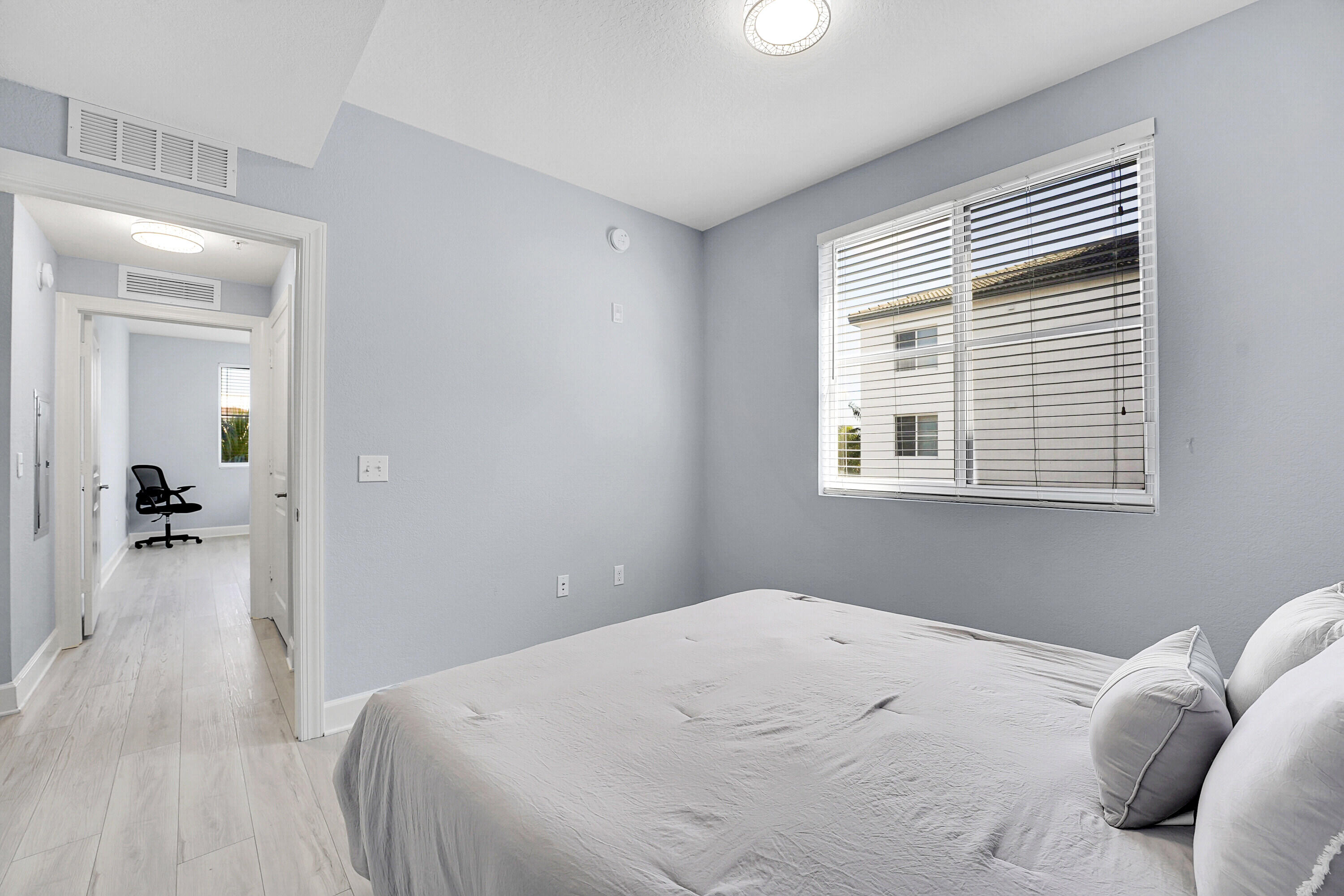 1690 Renaissance Commons Boulevard, Unit 1401 Boynton Beach, FL 33426 - Photo 23 of 43 a bedroom with a bed and a window