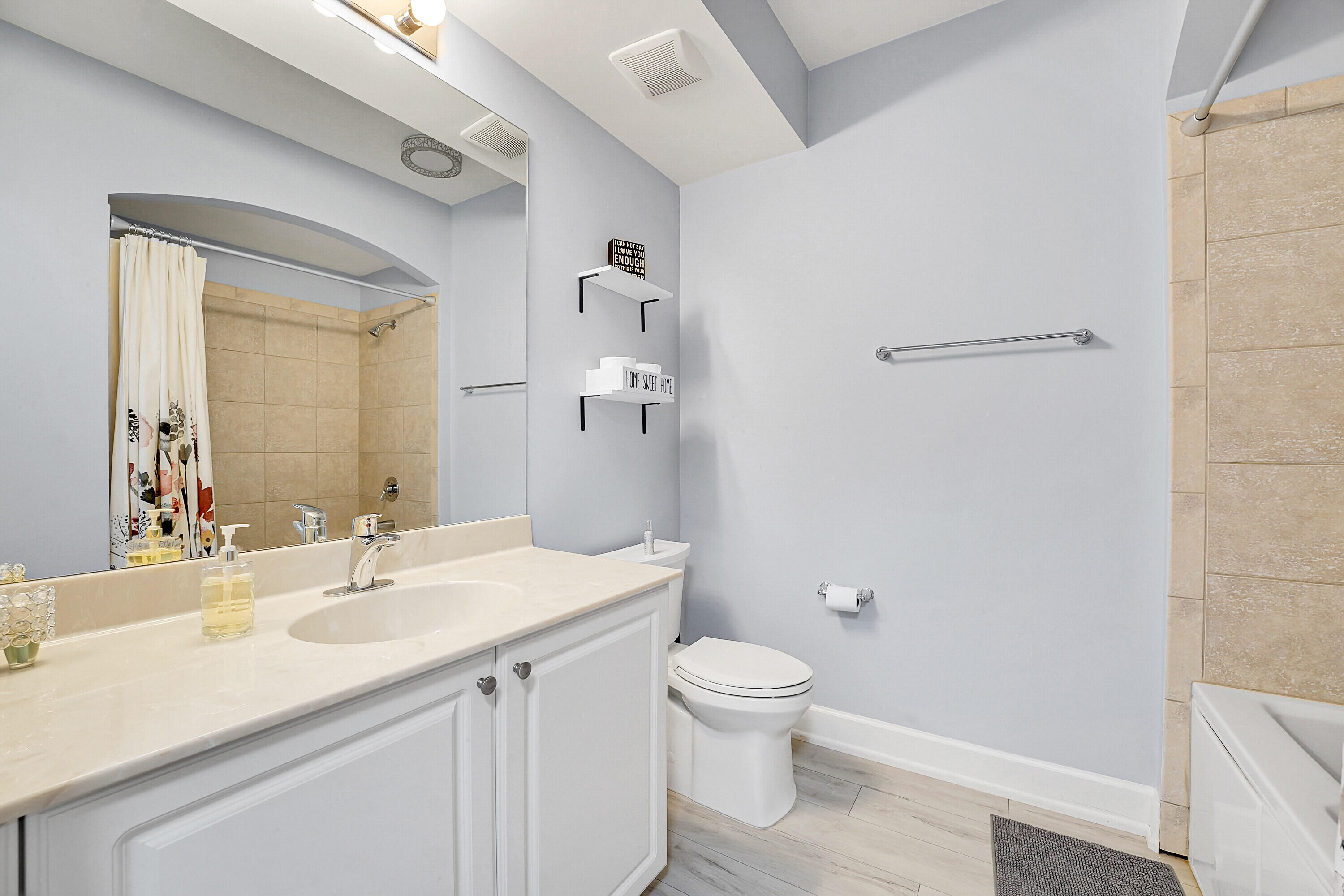 1690 Renaissance Commons Boulevard, Unit 1401 Boynton Beach, FL 33426 - Photo 27 of 43 a bathroom with a sink a toilet and shower