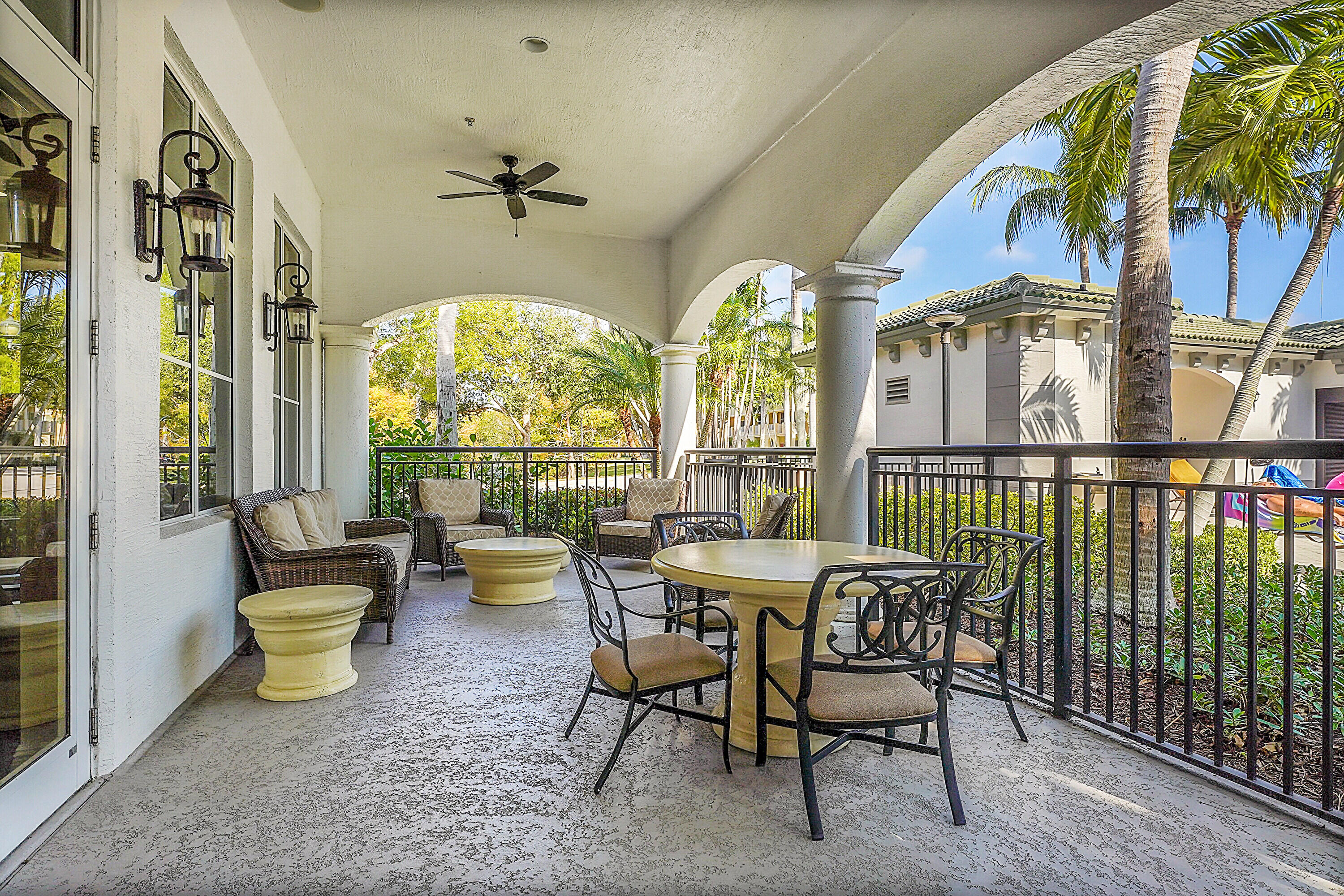 1690 Renaissance Commons Boulevard, Unit 1401 Boynton Beach, FL 33426 - Photo 32 of 43 a view of a dining room with furniture a chandelier and wooden floor