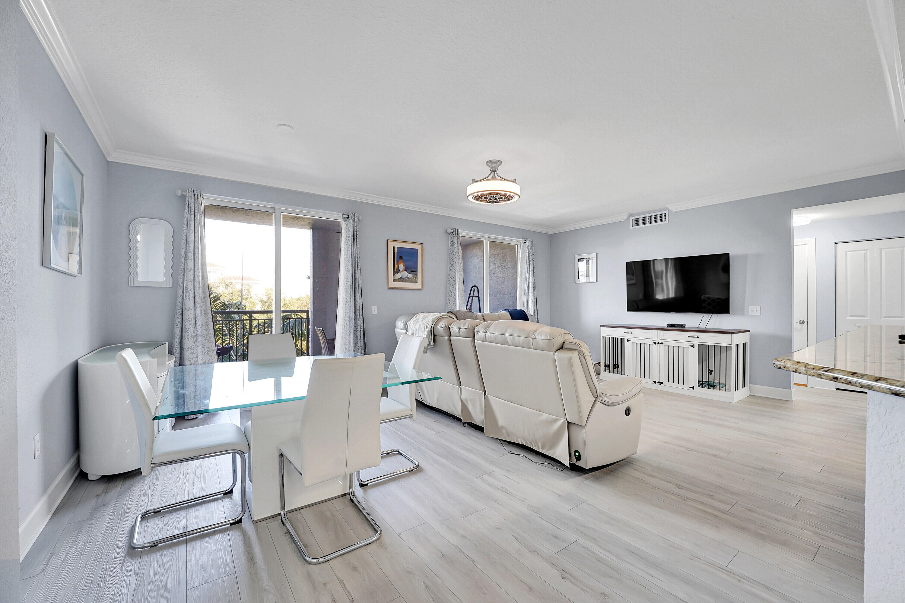 1690 Renaissance Commons Boulevard, Unit 1401 Boynton Beach, FL 33426 - Photo 9 of 43 a living room with furniture and a flat screen tv